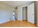 Cozy bedroom features light colored walls and hardwood floors, with a view into the hallway and closet at 20 Old Oak Ct, Covington, GA 30016