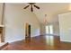 Spacious living room with vaulted ceilings, hardwood floors, fireplace, and access to an outdoor space at 20 Old Oak Ct, Covington, GA 30016
