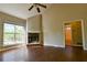 Bright and airy living room featuring a brick fireplace and large windows at 20 Old Oak Ct, Covington, GA 30016