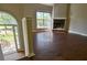 Cozy living room with a brick fireplace, large windows, and hardwood floors at 20 Old Oak Ct, Covington, GA 30016