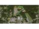 An aerial view showing community amenities including athletic fields, schools, and recreational areas surrounded by trees at 3556 Forest Hill Rd, Powder Springs, GA 30127