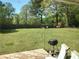 A spacious backyard featuring a grill, swing set, and fire pit area, perfect for outdoor entertaining at 3556 Forest Hill Rd, Powder Springs, GA 30127