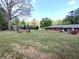 Spacious backyard with a lush lawn and a fire pit, perfect for outdoor entertaining at 3556 Forest Hill Rd, Powder Springs, GA 30127