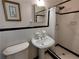 Bathroom featuring a pedestal sink, walk-in shower, and classic black and white tile at 3556 Forest Hill Rd, Powder Springs, GA 30127
