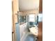 Cozy bathroom featuring blue tile, a walk-in tub, and a bright window at 3556 Forest Hill Rd, Powder Springs, GA 30127