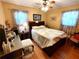 Cozy bedroom with wood floors, floral curtains, and comfortable furnishings at 3556 Forest Hill Rd, Powder Springs, GA 30127