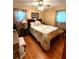 Cozy bedroom with natural light, hardwood floors, and patterned bedding at 3556 Forest Hill Rd, Powder Springs, GA 30127