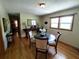 Bright dining room with hardwood floors and an elegant glass-top dining table at 3556 Forest Hill Rd, Powder Springs, GA 30127