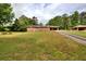 A one story brick house on a large lot with mature trees and a long driveway at 3556 Forest Hill Rd, Powder Springs, GA 30127