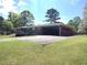 Charming brick home with a large driveway, a carport, and a well-maintained lawn at 3556 Forest Hill Rd, Powder Springs, GA 30127