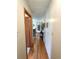 Long hallway with hardwood floors leading to a dining room filled with natural light and decorative wall art at 3556 Forest Hill Rd, Powder Springs, GA 30127
