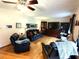 Large living room with hardwood floors, ceiling fan, and comfortable seating at 3556 Forest Hill Rd, Powder Springs, GA 30127