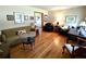 Cozy living room featuring hardwood floors, ample seating, and natural light at 3556 Forest Hill Rd, Powder Springs, GA 30127