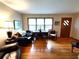 Bright living room with hardwood floors, desk area, and natural light at 3556 Forest Hill Rd, Powder Springs, GA 30127