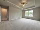 Large bedroom with neutral carpet, trey ceiling, and window views at 1217 Fern Ridge Ct # 16, Norcross, GA 30093