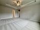 Spacious bedroom with neutral carpet and trey ceiling with fan at 1217 Fern Ridge Ct # 16, Norcross, GA 30093