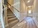 View of foyer with staircase, wainscoting, and hardwood flooring at 1217 Fern Ridge Ct # 16, Norcross, GA 30093