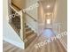 Entryway featuring hard wood style flooring, wide staircase, and elegant trim at 1217 Fern Ridge Ct # 16, Norcross, GA 30093