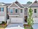 Charming townhome featuring gray brick, a two-car garage and a well-manicured front yard at 1217 Fern Ridge Ct # 16, Norcross, GA 30093