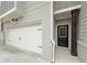 A townhome showcases a white two-car garage, a front door with dark trim, and address numbers at 1217 Fern Ridge Ct # 16, Norcross, GA 30093