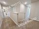 Upstairs hallway with neutral walls and carpet, leading to the bedrooms and bathrooms at 1217 Fern Ridge Ct # 16, Norcross, GA 30093