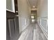 Entry view of a hallway with hardwood floors, neutral paint, and detailed wall trim and molding at 1217 Fern Ridge Ct # 16, Norcross, GA 30093