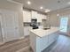 Kitchen boasts white cabinets, stainless appliances, quartz countertops, and eat-in island at 1217 Fern Ridge Ct # 16, Norcross, GA 30093