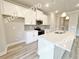 Contemporary kitchen featuring a central island with quartz countertop and stainless steel appliances at 1217 Fern Ridge Ct # 16, Norcross, GA 30093