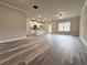 Bright living room with wood-look flooring, neutral paint, and a view into the kitchen at 1217 Fern Ridge Ct # 16, Norcross, GA 30093