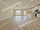 Open floorplan shows the kitchen and living room, with hardwood flooring and ample natural light at 1217 Fern Ridge Ct # 16, Norcross, GA 30093