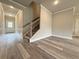 Bright living room with hardwood floors, neutral paint and views of the front door and staircase at 1217 Fern Ridge Ct # 16, Norcross, GA 30093