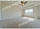 Spacious main bedroom with tray ceiling, ceiling fan, and large window at 1217 Fern Ridge Ct # 16, Norcross, GA 30093