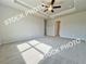 Spacious main bedroom featuring a tray ceiling and neutral carpeting at 1217 Fern Ridge Ct # 16, Norcross, GA 30093