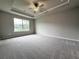 Main bedroom features a ceiling fan and large window at 1217 Fern Ridge Ct # 16, Norcross, GA 30093