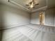 Spacious main bedroom with plush carpeting, neutral paint, and tray ceiling at 1217 Fern Ridge Ct # 16, Norcross, GA 30093