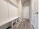 Mud room features bench with storage, coat hooks, and access to garage at 1217 Fern Ridge Ct # 16, Norcross, GA 30093