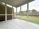 A screened patio with tiled floor offers views of the backyard with a wooden fence perimeter at 1217 Fern Ridge Ct # 16, Norcross, GA 30093