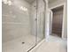 Bathroom shower with glass door and tiled floor leading to walk-in closet at 1217 Fern Ridge Ct # 16, Norcross, GA 30093