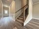 Entryway with staircase features hardwood floors, neutral paint, and detailed wall trim and molding at 1217 Fern Ridge Ct # 16, Norcross, GA 30093