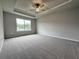 Spacious bedroom featuring a tray ceiling with fan and a large window with ample natural light at 1227 Fern Ridge Ct # 17, Norcross, GA 30093