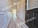 A foyer with decorative trim and wood-look floors, and a dark front door at 1227 Fern Ridge Ct # 17, Norcross, GA 30093