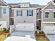 New construction townhome with a two-car garage and beautifully landscaped front yard at 1227 Fern Ridge Ct # 17, Norcross, GA 30093