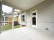 View of screened porch featuring a brick wall accent and access to the backyard at 1227 Fern Ridge Ct # 17, Norcross, GA 30093
