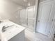 Elegant bathroom with double sink vanity, quartz countertop, tile floors, and a glass-enclosed shower at 1237 Fern Ridge Ct # 18, Norcross, GA 30093