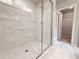 Modern bathroom features a glass enclosed shower with marble tile and access to a walk-in closet at 1237 Fern Ridge Ct # 18, Norcross, GA 30093