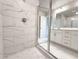 Bathroom featuring glass shower doors, marble tiling and a white double sink vanity at 1237 Fern Ridge Ct # 18, Norcross, GA 30093
