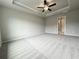 Spacious bedroom featuring plush carpet, ceiling fan, and en suite bathroom at 1237 Fern Ridge Ct # 18, Norcross, GA 30093