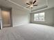A large bedroom features plush carpet, neutral walls, tray ceiling and a window at 1237 Fern Ridge Ct # 18, Norcross, GA 30093