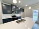 Modern kitchen featuring navy blue cabinets, white quartz countertops, a stainless steel oven, and an island with sink at 1237 Fern Ridge Ct # 18, Norcross, GA 30093