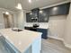 Modern kitchen featuring navy blue cabinets, white quartz countertops, a stainless steel oven, and an island with sink at 1237 Fern Ridge Ct # 18, Norcross, GA 30093